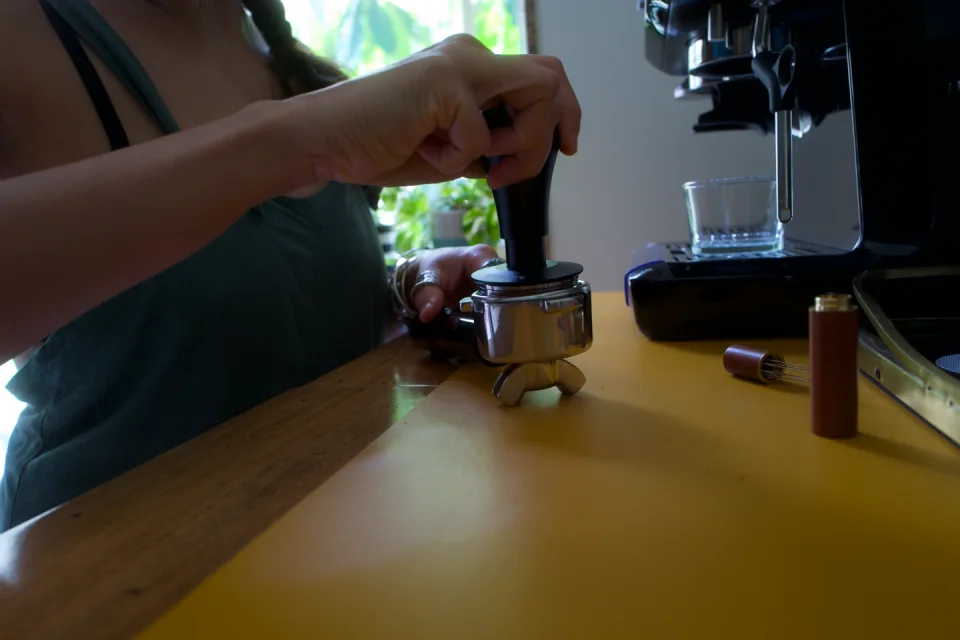 Sabah preparing coffee at her kitchen counter