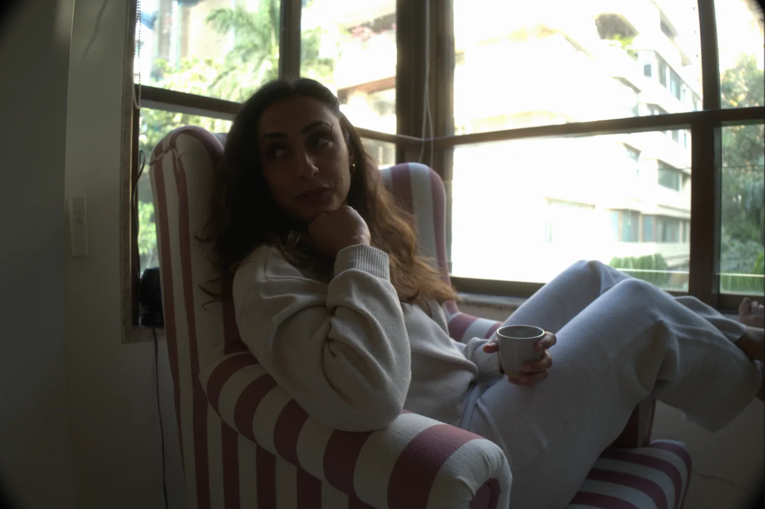 Sabah seated in a quiet interior