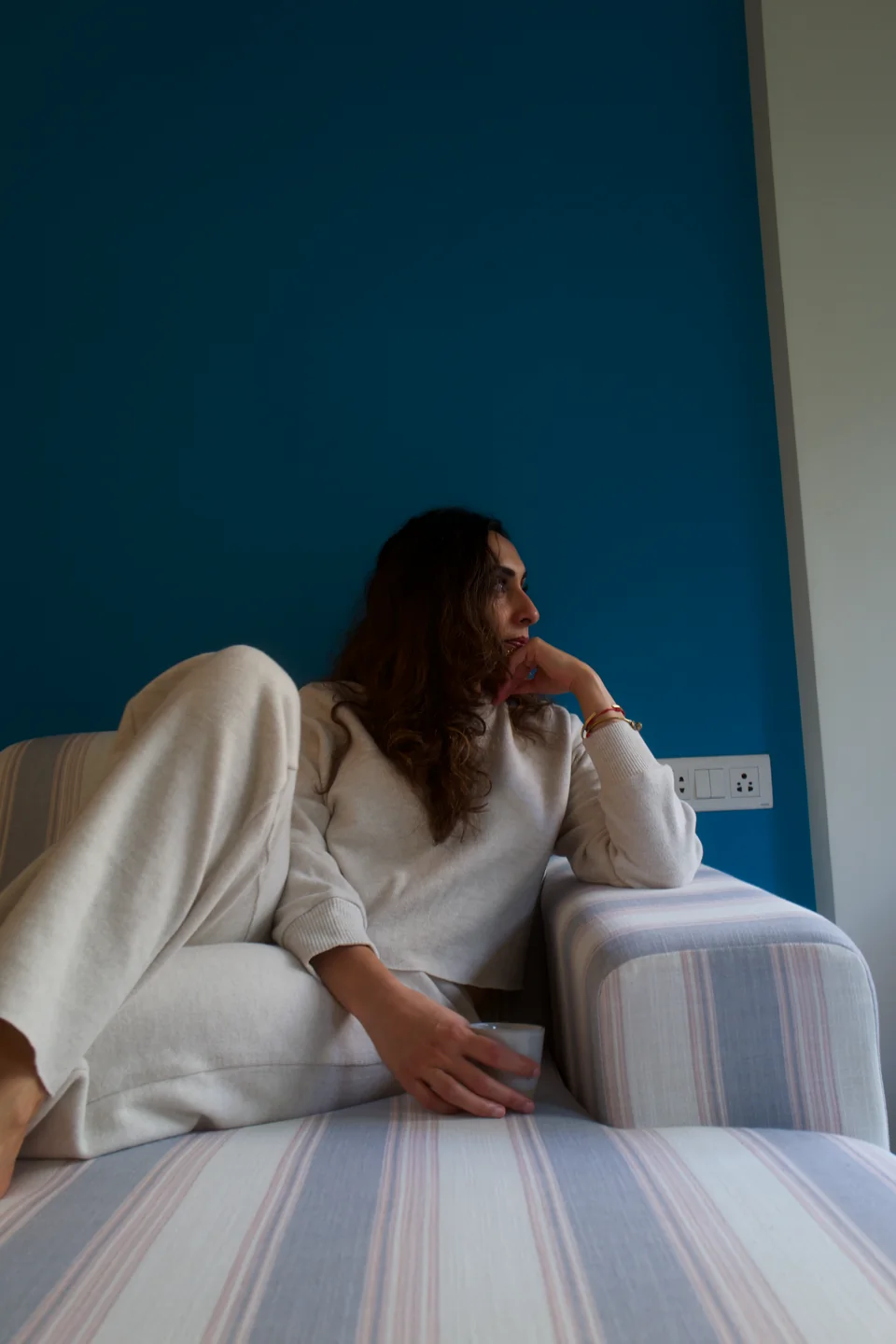 Sabah resting in an armchair, looking towards the window